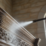 A 24/7 Restoration technician uses dry ice blasting to remove soot from intricate historic wooden millwork, demonstrating the 'Surgical Remediation' technique for properties such as those in River Oaks.