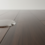 Close-up of a cupped hardwood floor with a moisture meter reading