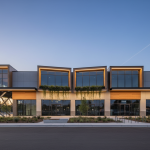 Damaged Humble retail strip mall facade undergoing engineering-led structural reconstruction.