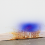 A 24/7 Restoration Specialists technician uses an infrared camera on a wall section with a yellowed baseboard. The thermal scan reveals a cool, dark area, pinpointing hidden wall cavity seepage and moisture issues that cause baseboards to turn yellow from capillary suction.