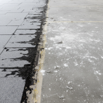 Close-up of commercial flooring displaying various failures post-leak, demonstrating need for expert diagnosis.