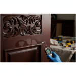 Close-up of water-damaged custom Sterling Millwork, showing subtle discoloration and warping, demonstrating the critical need for forensic drying and expert restoration to prevent the Hygroscopic Sponge Effect.