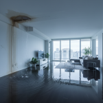 A concerned homeowner in a Houston condo points to severe water damage, including large discolored stains and sagging drywall, on their ceiling caused by a neighbor's upstairs leak. This image illustrates the type of incident where 24/7 Restoration Specialists provides urgent water damage restoration in Houston, Texas, and assists with complex claims involving the subrogation process.