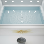 A filled shower pan sealed with a specialized drain plug, demonstrating 24/7 Restoration Specialists' hydrostatic test to find leaks causing 1st-floor ceiling water damage.