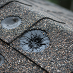 Close-up of functional hail damage on roofing shingles, crucial for roof claim appeals against cosmetic exclusion.