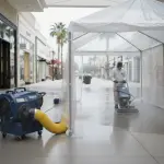 Advanced restoration equipment actively mitigating significant water damage within a Houston strip mall retail space, reflecting 24/7 Restoration Specialists' 'Retail Resilience: Rapid Response' services.