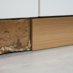 Swollen particle board cabinet damage close up