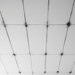 A white residential ceiling exhibits distinct dark, parallel stripes, often found along joist lines. This clear visual demonstrates thermal tracking, or 'ghosting,' where soot and dust adhere to colder surfaces, as explained in our article: 'Thermal Tracking ‘Ghosting’: Why Your Walls Have Black Stripes'.