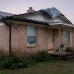 Houston-area brick home with wet siding after rain