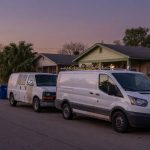 Two unmarked white vans on a Houston residential street